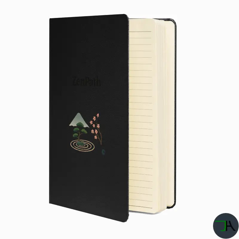 Black notebook with artistic design on cover and cream interior pages on a white background